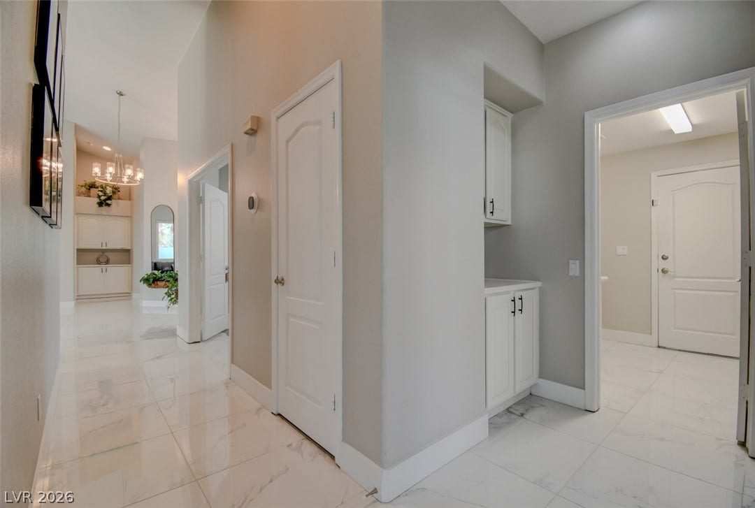 Polished tile flooring and high ceilings elevate this bright, functional transition area.