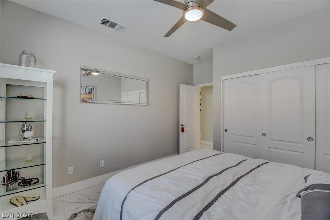 Gleaming stone tile flooring and tall closets define this quiet, comfortable retreat.