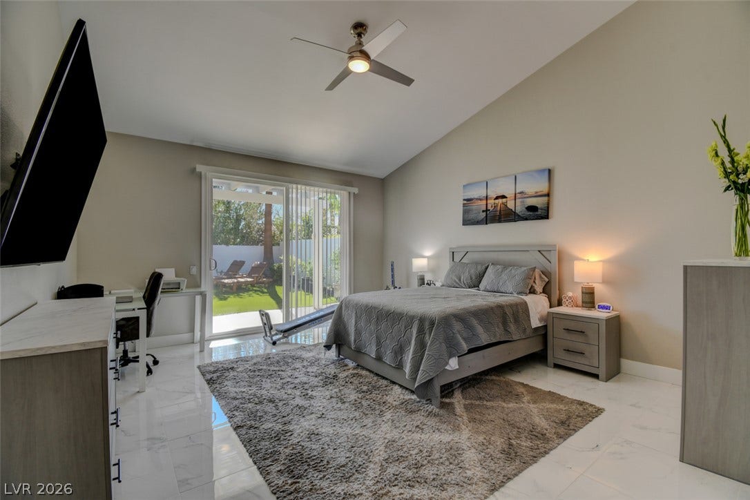 Gleaming tile floors and vaulted ceilings elevate this modern bedroom opening directly to the yard.