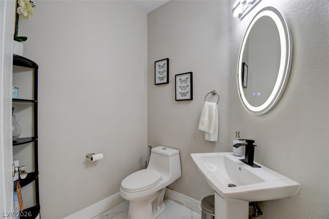 Clean lines and modern fixtures define this stylishly neutral half bath.