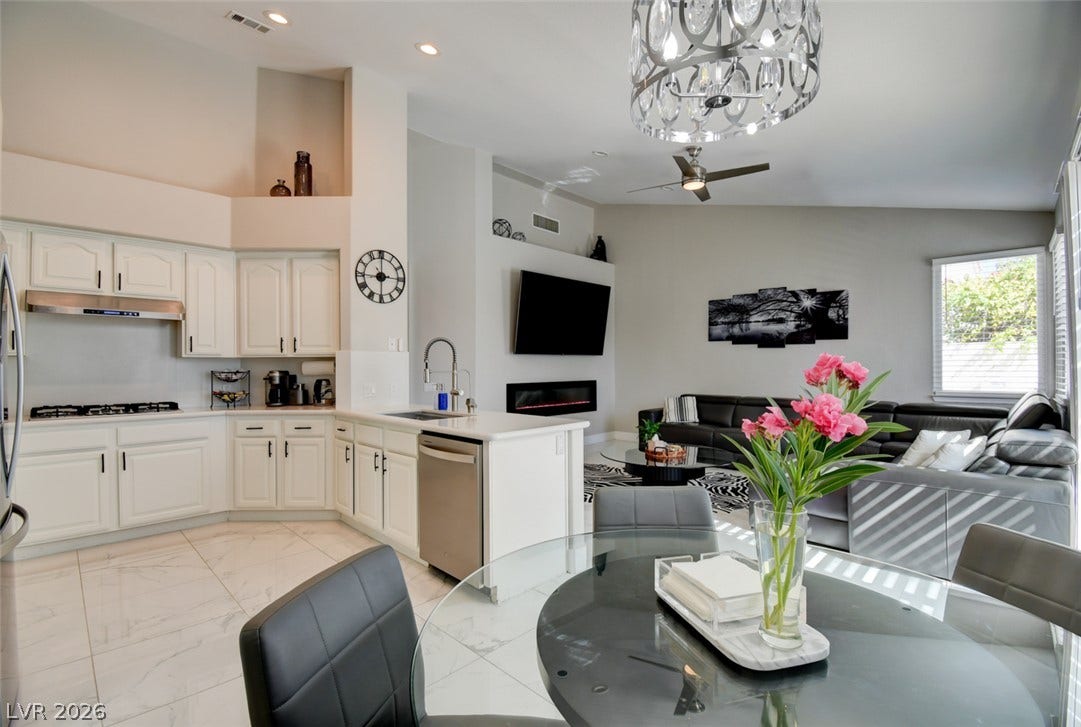 Gleaming tile floors anchor an airy, open layout connecting the kitchen and living spaces.