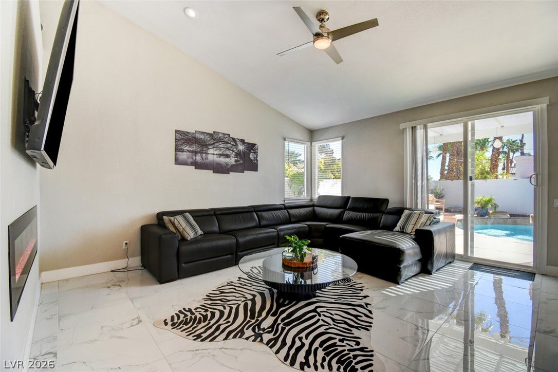 Polished tile flooring and high vaulted ceilings define this contemporary living space.