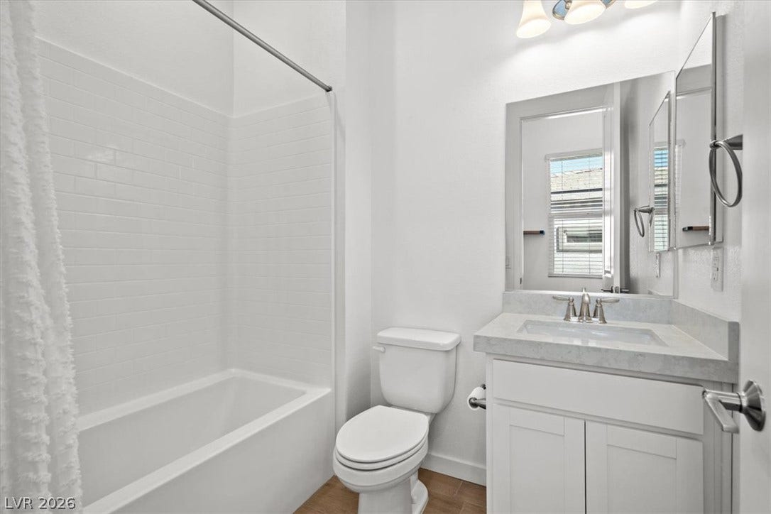 Clean lines and a subway-tiled tub enclosure define this sleek secondary bathroom.
