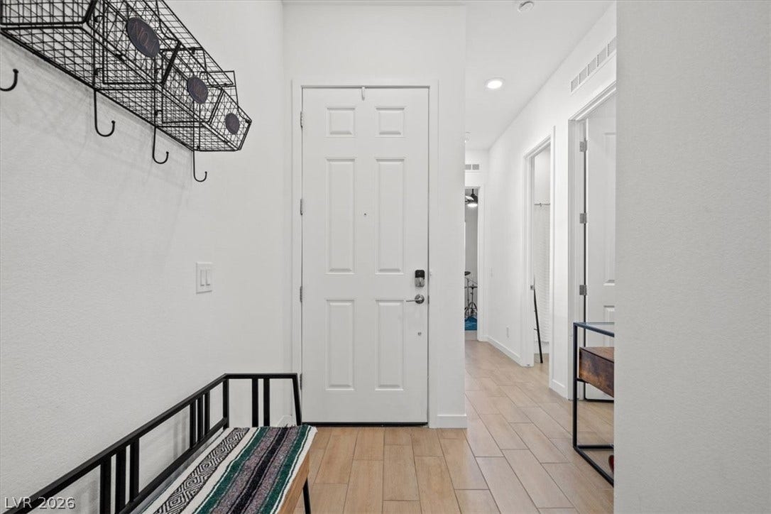 Wood-look tile floors welcome guests inside this bright and inviting entrance foyer.