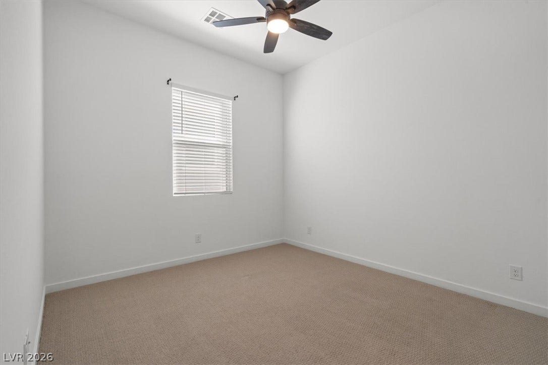 Crisp neutral walls and plush carpeting create a versatile canvas ready for personalization.