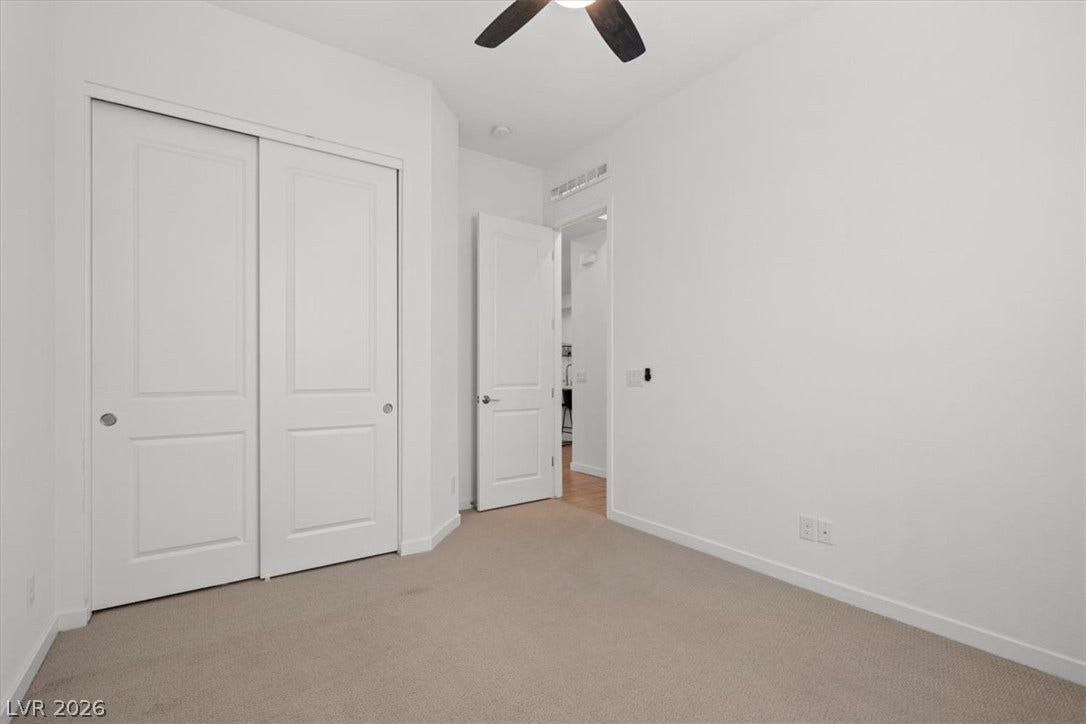 Plush carpeting and clean architectural lines define this comfortable secondary bedroom space.