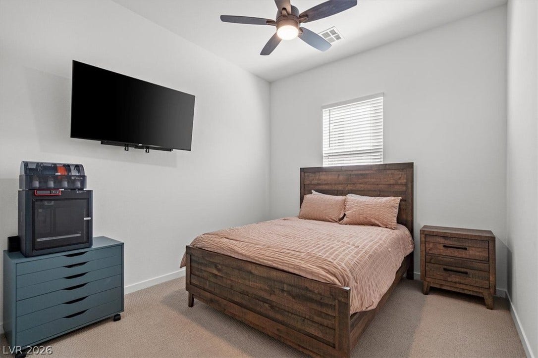 Crisp walls and plush carpeting define this restful secondary bedroom retreat.