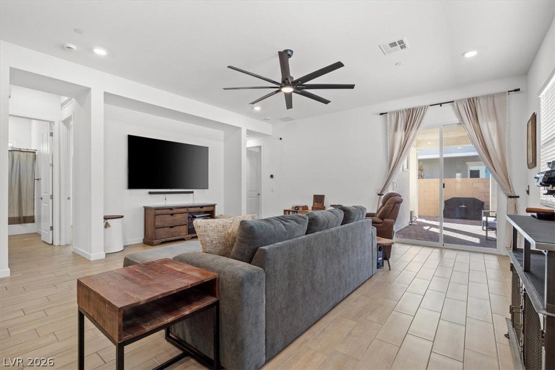 Gleaming tile floors and sliding glass doors define this airy living space.