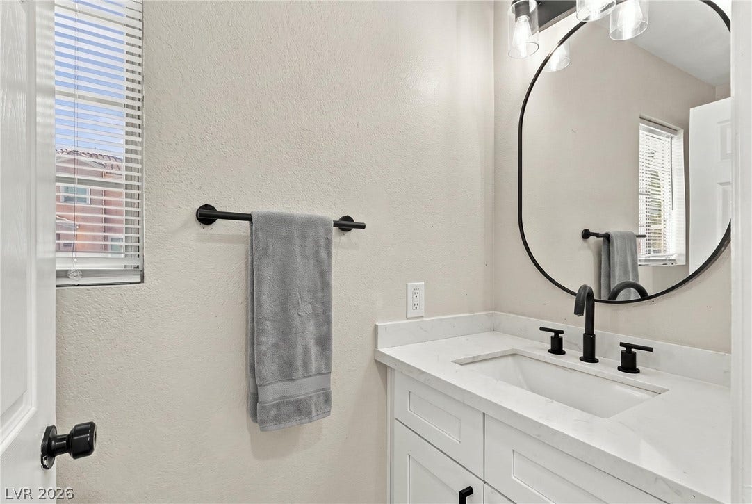Clean lines and a stone countertop define this refined bathroom space.