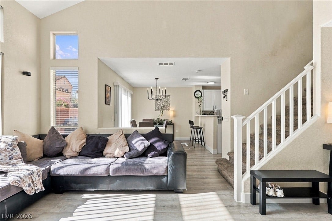 Vaulted ceilings and wood-look flooring enhance this inviting multi-level interior layout.