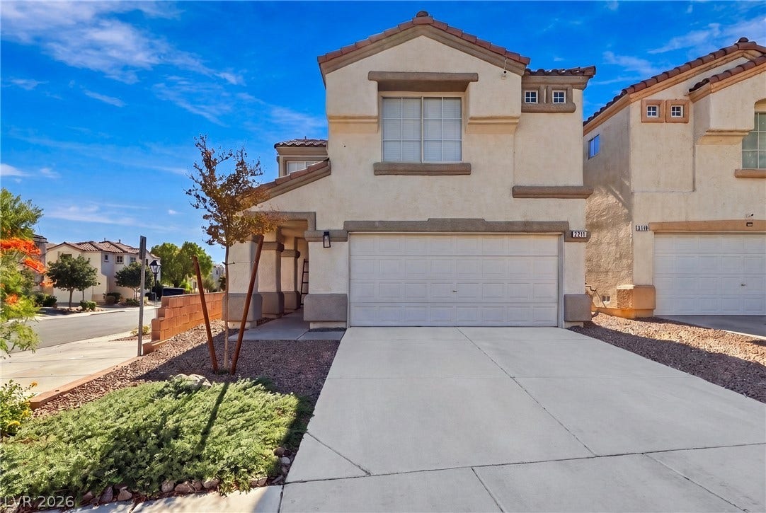 A spacious driveway leads directly to the integrated two-car garage of this multi-level home.