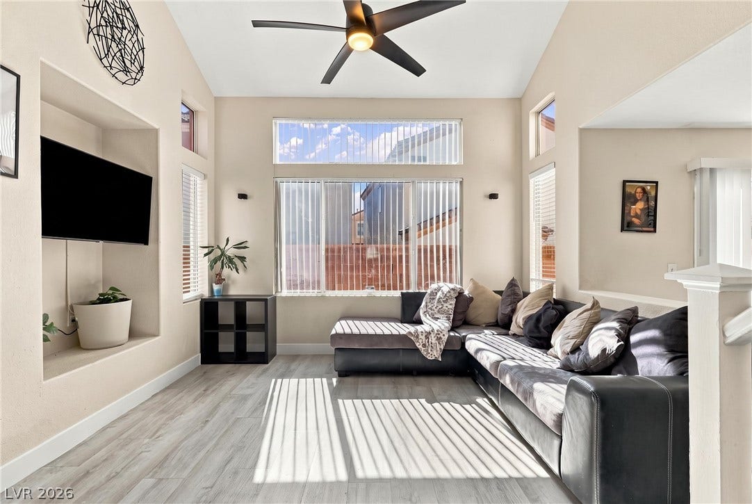 High vaulted ceilings and tall windows elevate this welcoming living space.