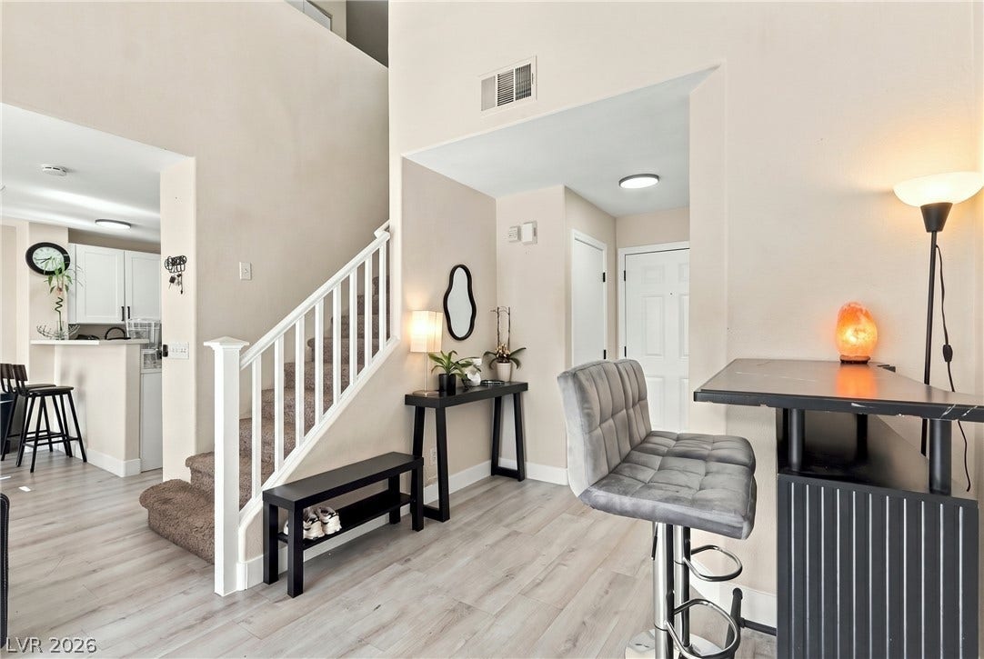 Soaring ceilings and modern plank flooring anchor this bright, multi-level entryway.
