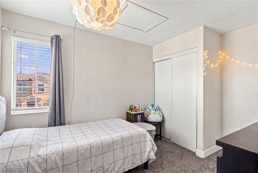 Plush carpeting and a large window create a comfortable, inviting atmosphere.