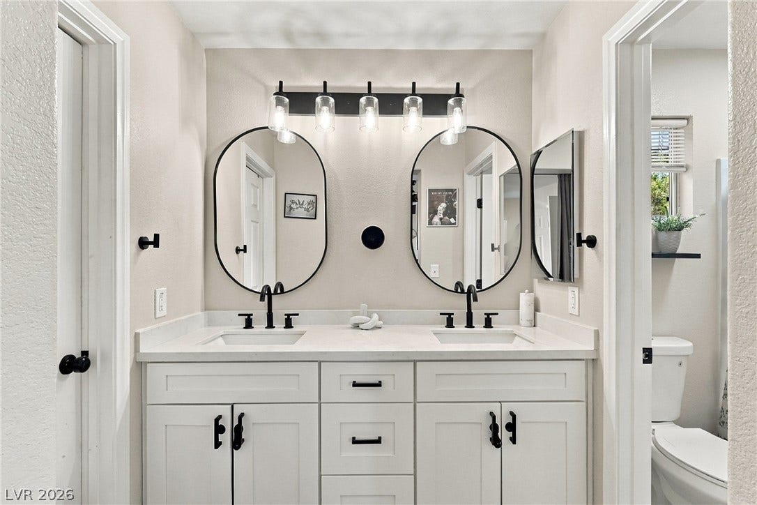 Clean lines and a spacious double vanity anchor this modern bathroom design.