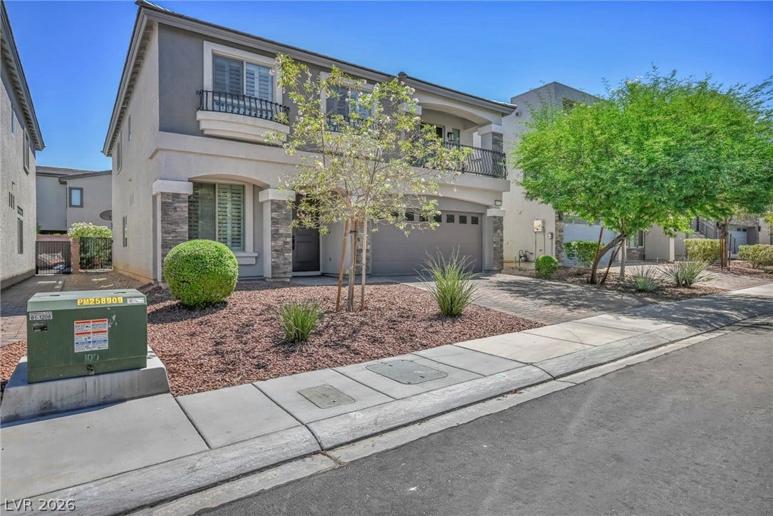 6571 Tangled Vines Avenue, Las Vegas, NV 89139 Stone accents and a second-story balcony define this contemporary dual-level stucco home.