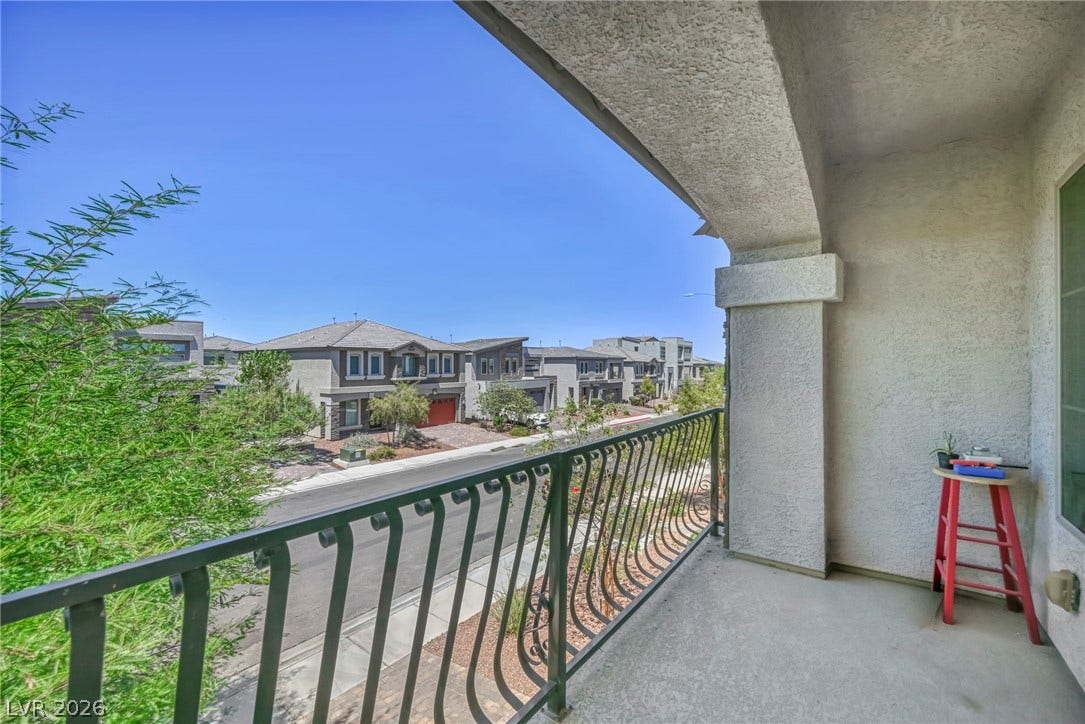 6571 Tangled Vines Avenue, Las Vegas, NV 89139 An elevated perspective overlooks the surrounding neighborhood from a covered balcony with concrete flooring.