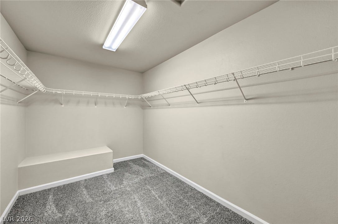 6571 Tangled Vines Avenue, Las Vegas, NV 89139 A spacious walk-in closet includes wall-to-wall carpeting and built-in wire shelving.