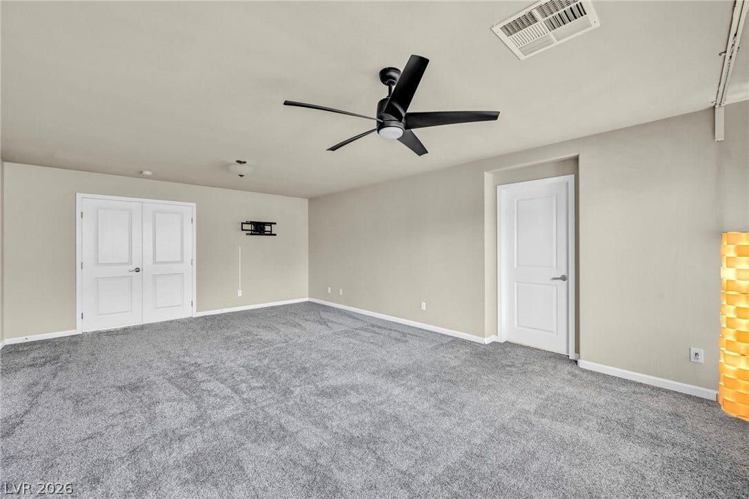 6571 Tangled Vines Avenue, Las Vegas, NV 89139 Plush wall-to-wall carpeting and clean neutral walls define this versatile interior living area.