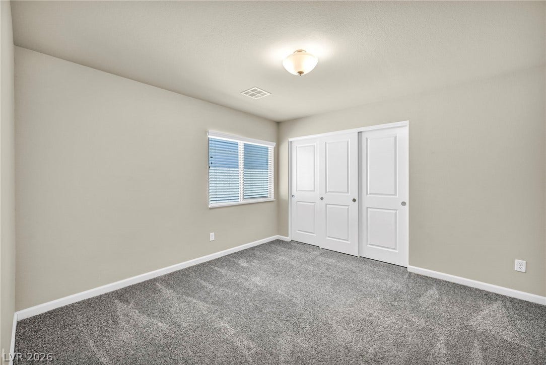 6571 Tangled Vines Avenue, Las Vegas, NV 89139 Plush carpeting and a wide closet define this comfortable secondary bedroom space.