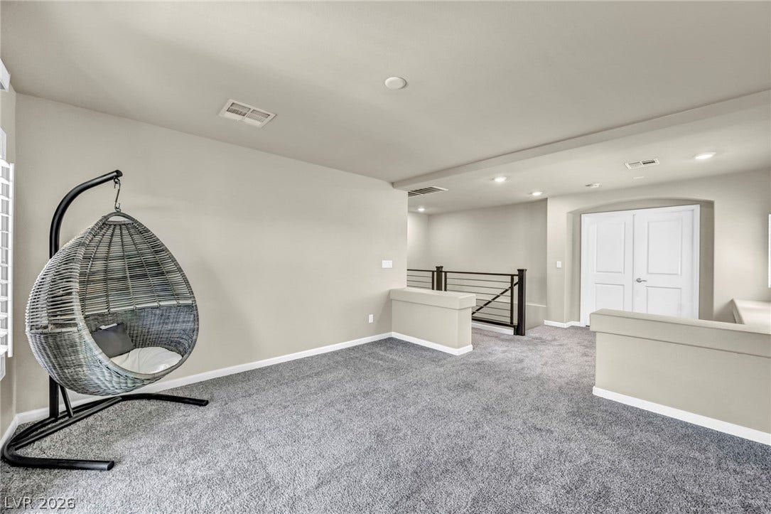 6571 Tangled Vines Avenue, Las Vegas, NV 89139 A spacious upper-level loft features wall-to-wall carpeting and recessed lighting.
