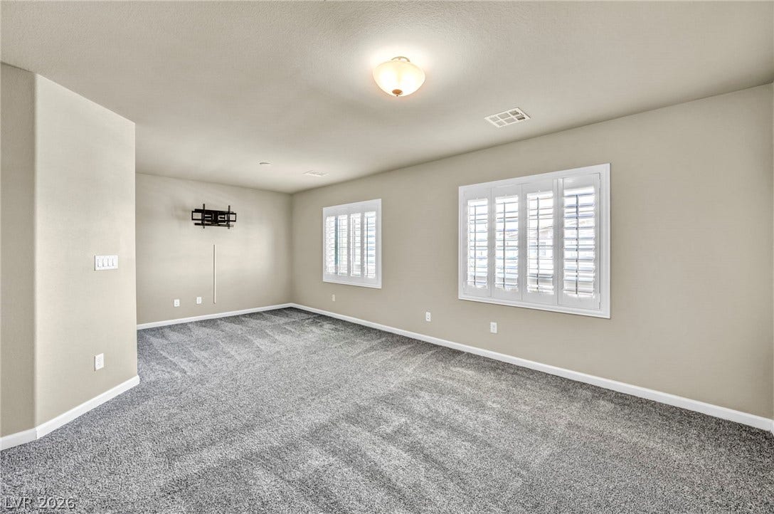 6571 Tangled Vines Avenue, Las Vegas, NV 89139 Plush carpeting and plantation shutters highlight this versatile secondary living space.