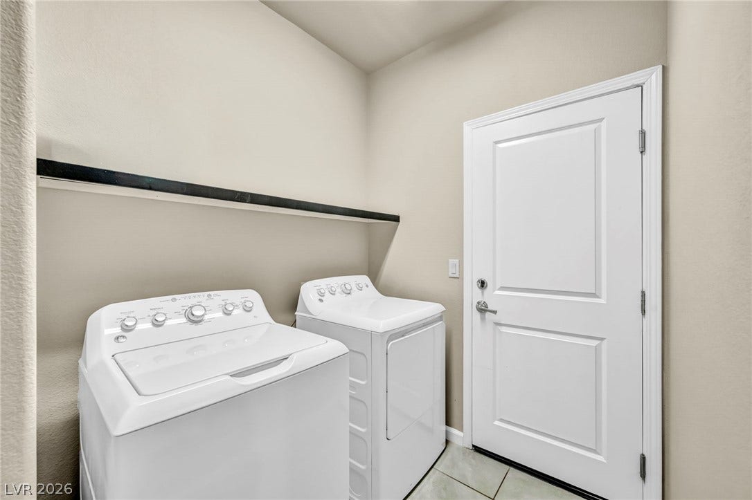 6571 Tangled Vines Avenue, Las Vegas, NV 89139 Functional laundry space features durable tile flooring and a built-in overhead shelf.