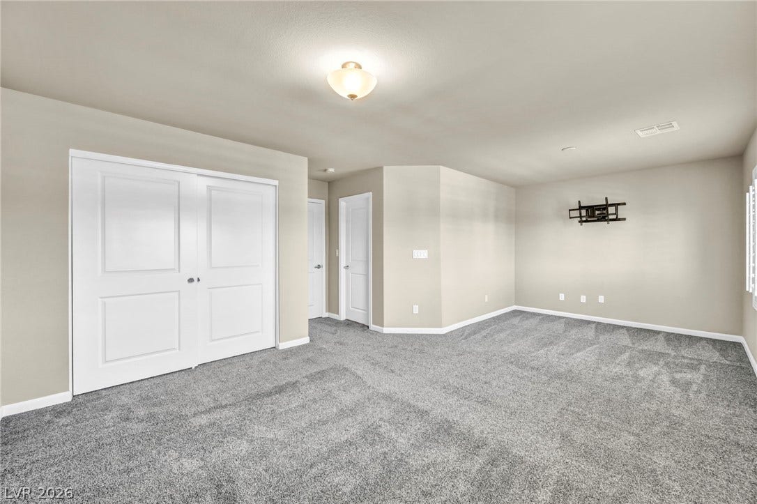 6571 Tangled Vines Avenue, Las Vegas, NV 89139 Plush carpeting anchors this versatile bonus room with smooth walls and clean millwork.