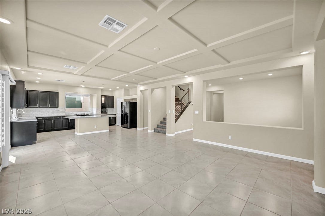 6571 Tangled Vines Avenue, Las Vegas, NV 89139 An open layout connects the tiled living space to a kitchen under coffered ceilings.
