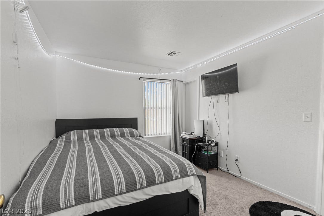 5015 Droubay Drive, Las Vegas, NV 89122 Smooth white walls and soft carpeting define this cozy personal retreat.