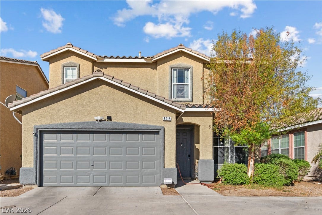 5015 Droubay Drive, Las Vegas, NV 89122 Stucco exterior and tiled roofline define this multi-level home with an attached garage.