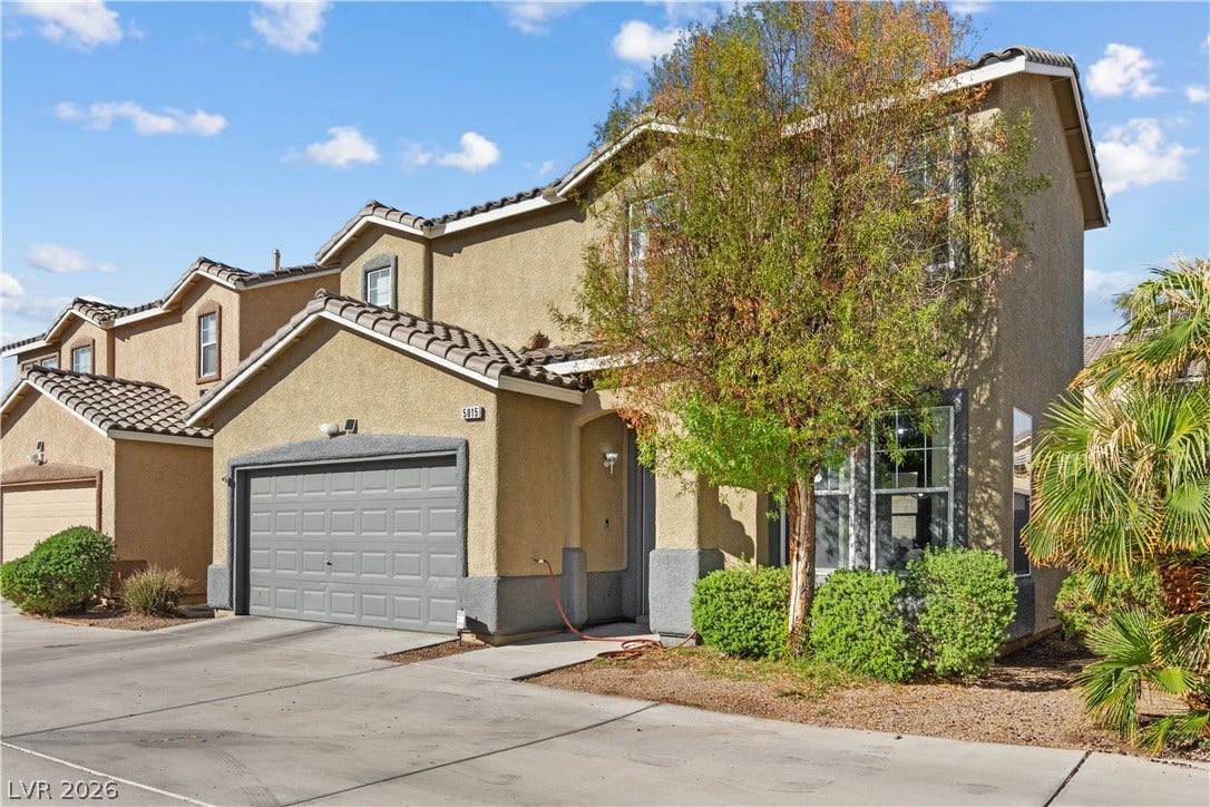 5015 Droubay Drive, Las Vegas, NV 89122 Multi-level stucco architecture pairs with a tile roof and a private front entrance.