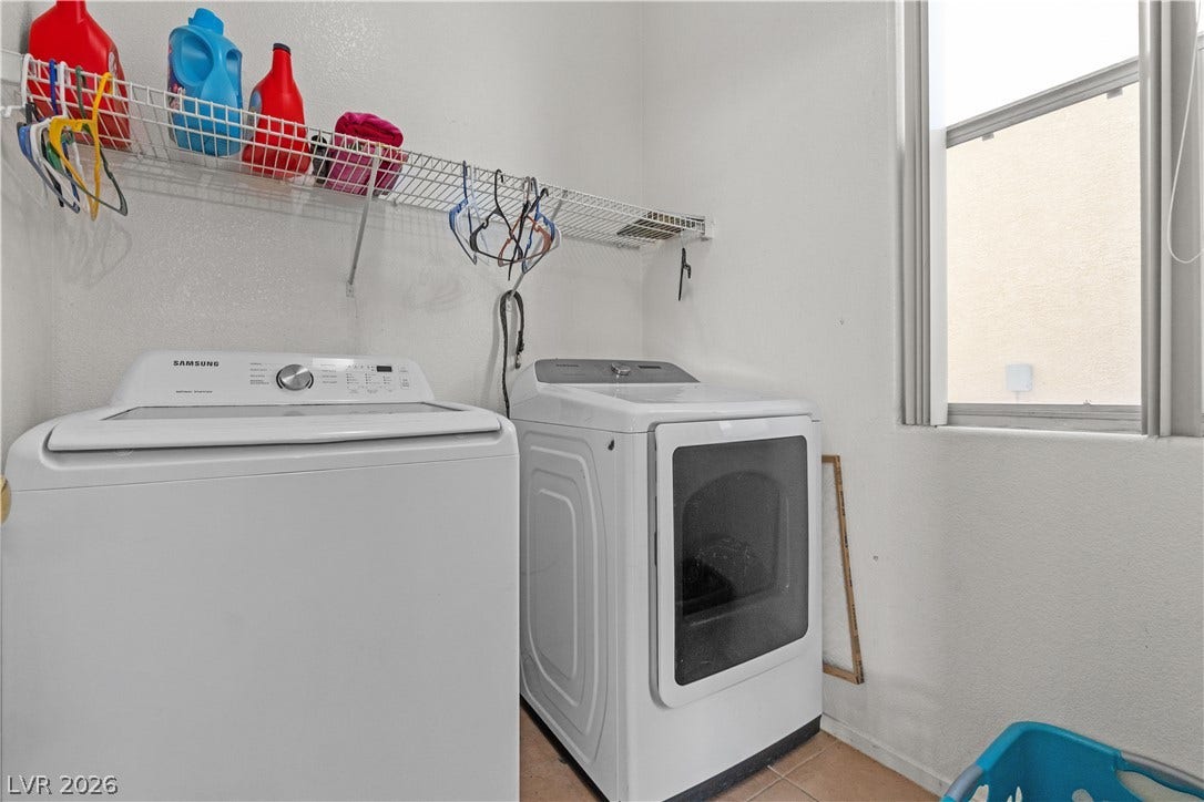 5015 Droubay Drive, Las Vegas, NV 89122 A window brings natural light into this functional laundry space with overhead storage wire shelving.