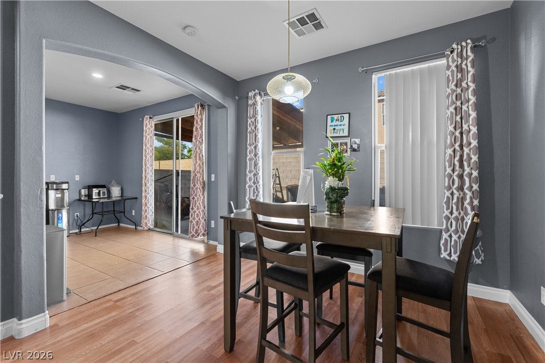 5015 Droubay Drive, Las Vegas, NV 89122 An open doorway connects the dining area to a sunlit room with sliding glass doors.
