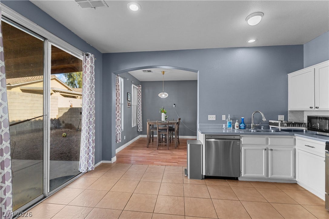5015 Droubay Drive, Las Vegas, NV 89122 Sliding glass doors open directly to the patio from this tile-floored kitchen area.