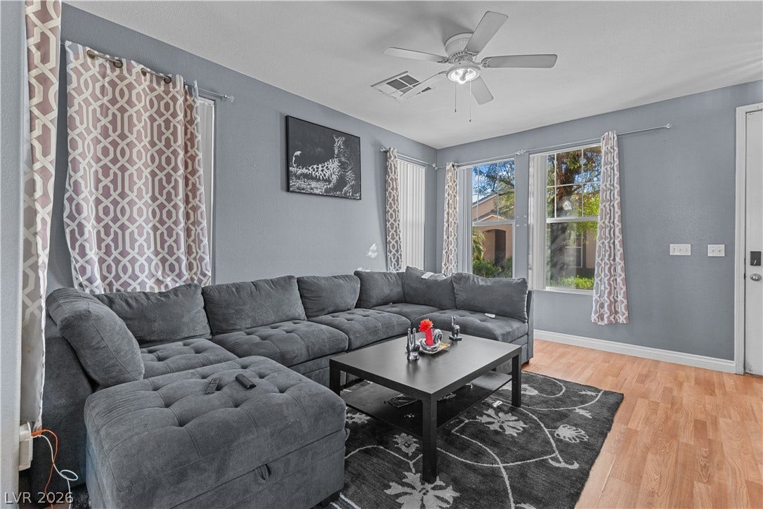 5015 Droubay Drive, Las Vegas, NV 89122 Warm wood flooring and abundant natural light create a welcoming living space.