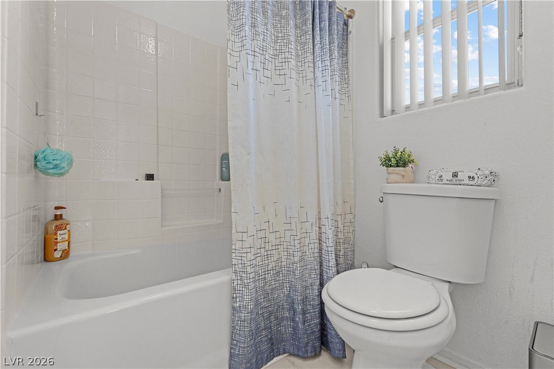 5015 Droubay Drive, Las Vegas, NV 89122 Tiled walls and a classic bathtub define this practical bathroom space.