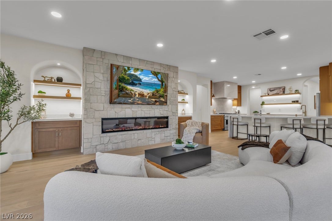 2734 Cherrydale Falls Drive, Henderson, NV 89052 A stone fireplace anchors the open-concept living area with seamless flow into the kitchen.