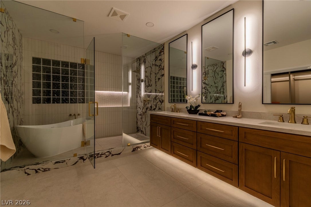 2734 Cherrydale Falls Drive, Henderson, NV 89052 A freestanding tub and a spacious dual vanity define this luxury bathroom retreat.