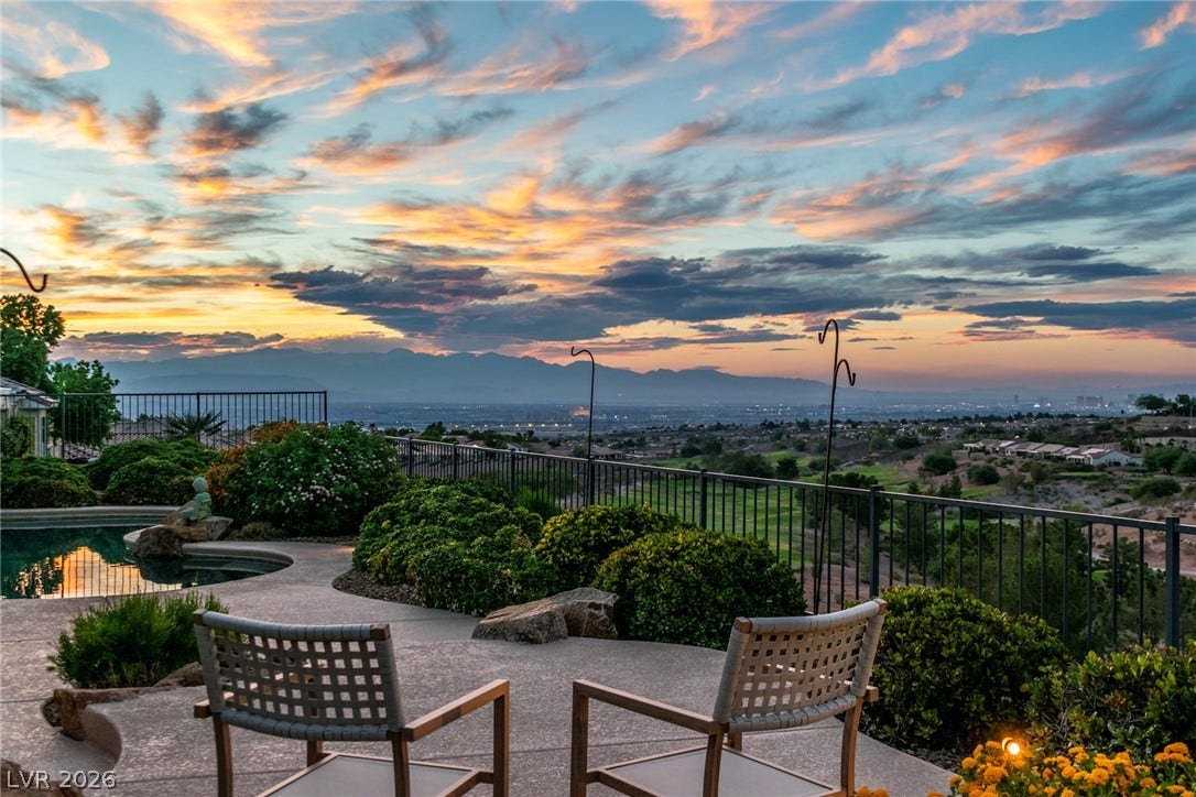 2734 Cherrydale Falls Drive, Henderson, NV 89052 Panoramic mountain and valley vistas unfold from the back patio and pool deck at sunset.