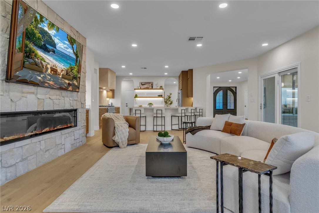 2734 Cherrydale Falls Drive, Henderson, NV 89052 An open floorplan seamlessly connects the stone fireplace hearth to the modern kitchen.