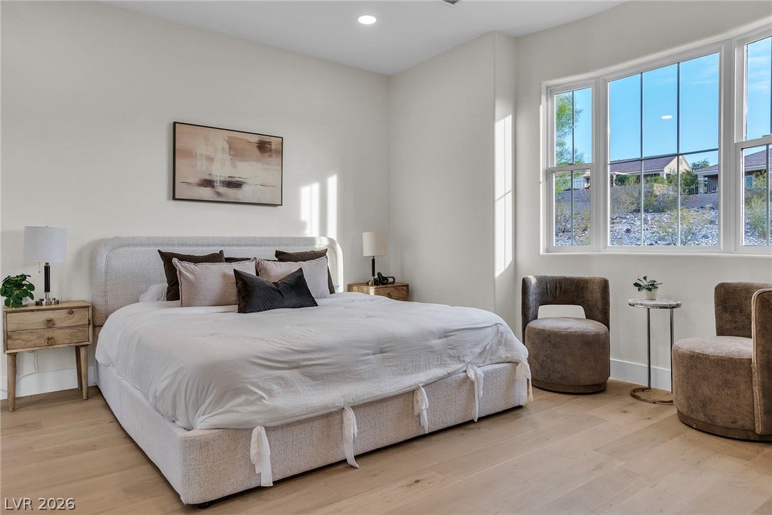 2734 Cherrydale Falls Drive, Henderson, NV 89052 Natural light streams through large windows, highlighting the clean lines and light wood flooring.