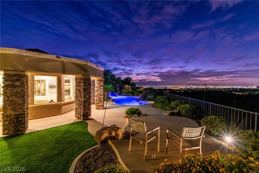 2734 Cherrydale Falls Drive, Henderson, NV 89052 Gaze across twinkling city lights from this elevated patio with stone accents.