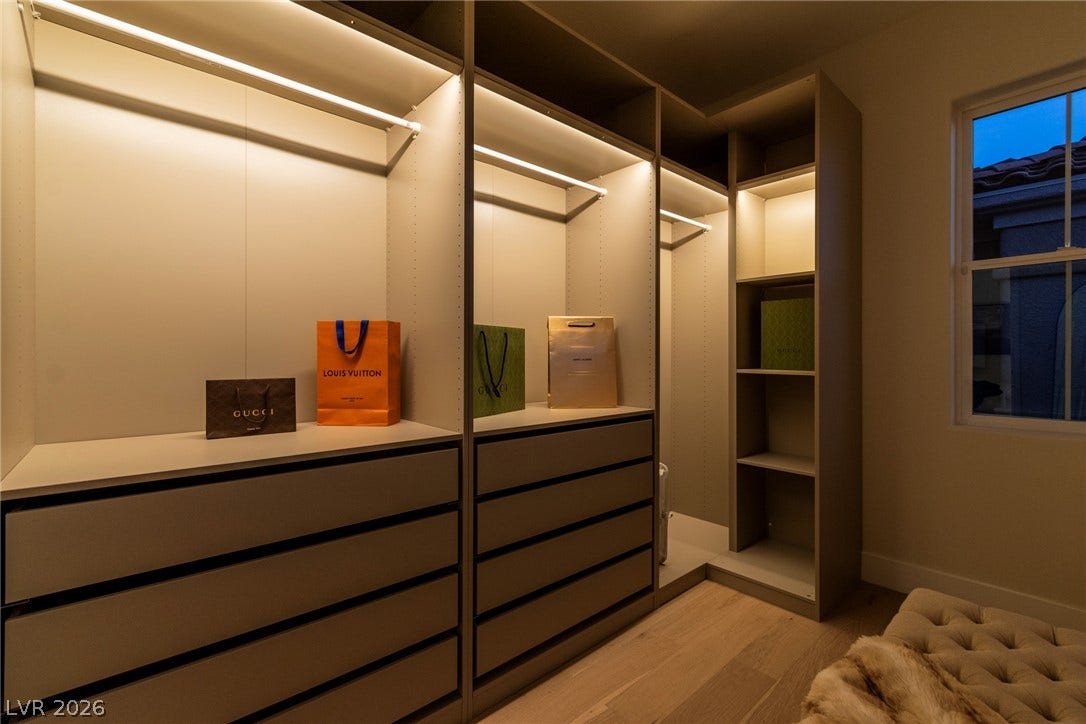 2734 Cherrydale Falls Drive, Henderson, NV 89052 Custom built-in cabinetry and integrated lighting define this organized walk-in closet space.
