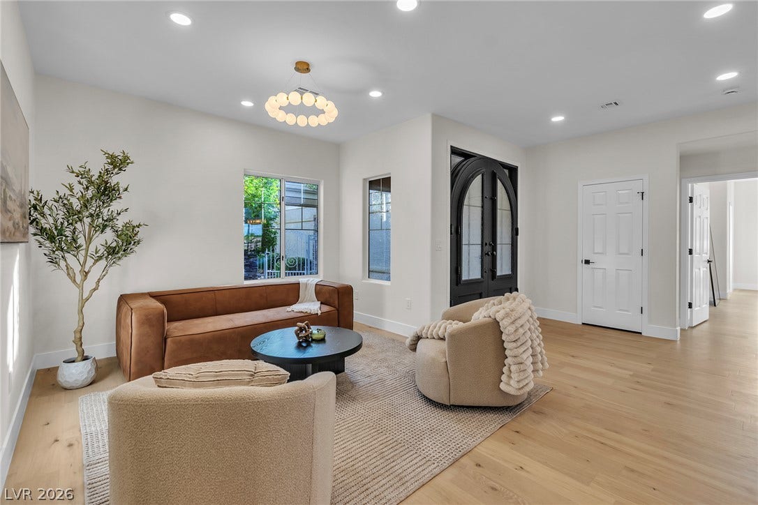 2734 Cherrydale Falls Drive, Henderson, NV 89052 Recessed lighting and warm wood flooring define this inviting, open entryway space.