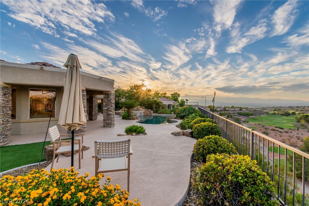 2734 Cherrydale Falls Drive, Henderson, NV 89052 An expansive concrete patio overlooks a lush golf course and scenic distant mountains.
