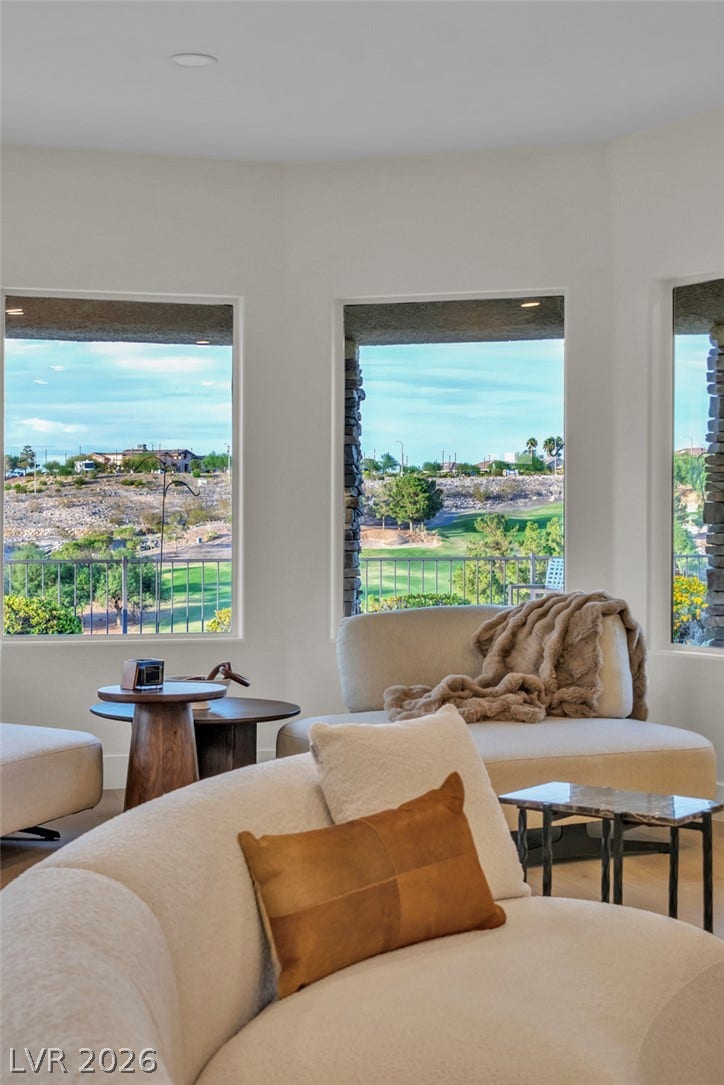 2734 Cherrydale Falls Drive, Henderson, NV 89052 Large picture windows frame elevated views of the green golf course beyond.