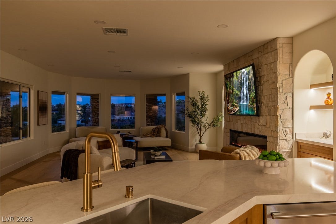 2734 Cherrydale Falls Drive, Henderson, NV 89052 An open layout flows effortlessly from the stone-faced fireplace to the sleek kitchen island.