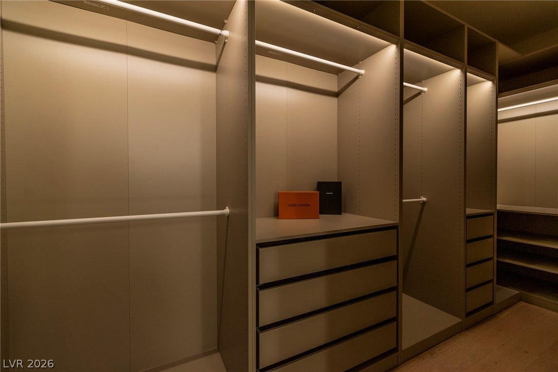 2734 Cherrydale Falls Drive, Henderson, NV 89052 Custom built-in shelving and integrated lighting elevate this spacious dressing area.