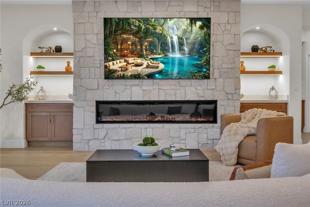 2734 Cherrydale Falls Drive, Henderson, NV 89052 An impressive stone fireplace anchors the living room alongside lighted display niches and hardwood floors.
